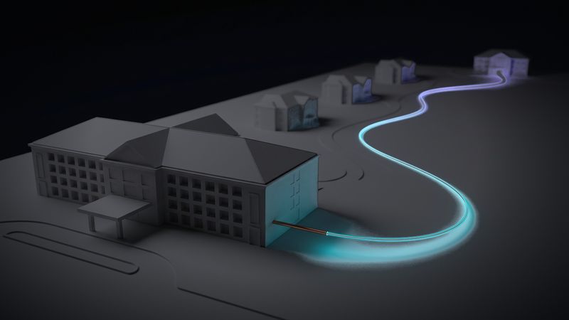Plastico di un complesso di edifici: dall'edificio principale una fibra arriva fino all'edificio più lontano, mentre un cavo di rame si ferma subito
